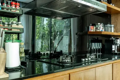 a kitchen with a black counter and a window at Baan Bua BT17 by Villacarte in Nai Harn Beach