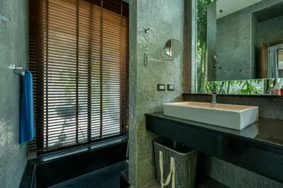 a bathroom with a sink and a mirror at Baan Bua BT17 by Villacarte in Nai Harn Beach
