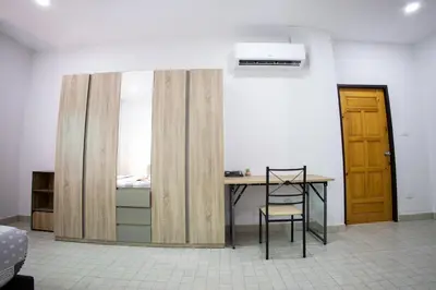 a room with a desk and a bed and a table at Grand View Premium in Patong Beach