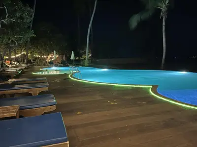 a swimming pool at night with lights on it at Better View Koh Yao Yai in Ko Yao Yai