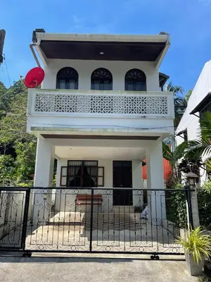 a white house with a balcony and a fence at 103/24 Kathu Waterfall in Phuket Town