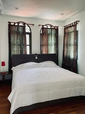 a bedroom with a large bed and two windows at 103/24 Kathu Waterfall in Phuket Town