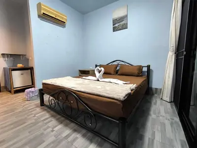 a bedroom with a large bed in a room at PhuketAirportCamping in Mai Khao Beach