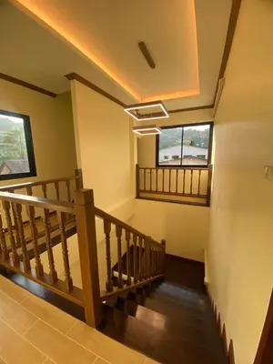 a staircase in a house with two windows at Kata Noi Place in Kata Beach