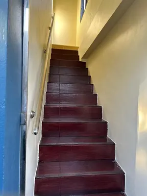 a staircase in a house with wooden steps at Kata Noi Place in Kata Beach