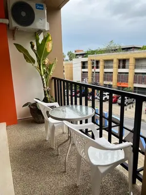 a balcony with a table and chairs on a balcony at Rawai Sea Beach in Phuket Town