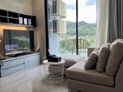 a living room with a flat screen tv and a couch at Kamala Beach P79 Exclusive Junior Suite in Kamala Beach