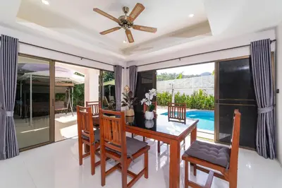 a dining room with a table and chairs and a ceiling fan at Villa Amaya, 2 Story Tropical Oasis with Green Hills View & Pool, Kamala Beach in Kamala Beach