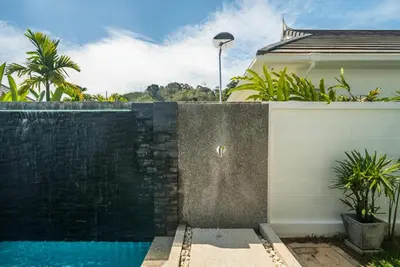 a swimming pool in front of a house at Deluxe pool villa at Kamala Garden View in Kamala Beach