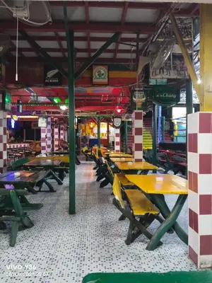 a group of tables and chairs in a restaurant at Reggaeinn in Phi Phi Don