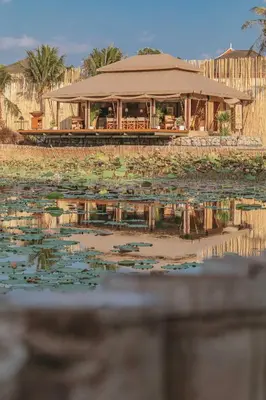 a house with a lot of lily pads in the water at Aladdin Luxury Camp Phuket in Phuket Town