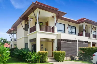 a large white house with a balcony at Laguna Luxury 2-Bed Pool Villa - Near Layan Beach in Layan Beach