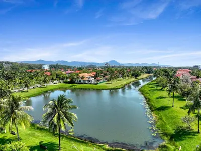 a river with palm trees in front of a town at Laguna Luxury 2-Bed Pool Villa - Near Layan Beach in Layan Beach