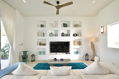 a living room with a couch and a tv at Nai Harn Beach 4 bedroom Pool Villa, Rawai, Phuket in Phuket Town