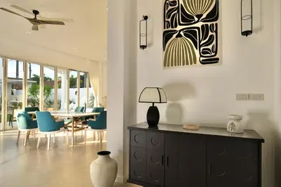 a living room with a table and blue chairs at Nai Harn Beach 4 bedroom Pool Villa, Rawai, Phuket in Phuket Town