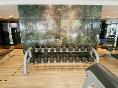 a gym with a bunch of dumbbells in a gym at The Deck Condo Studios Patong w/ pool fitness in Patong Beach