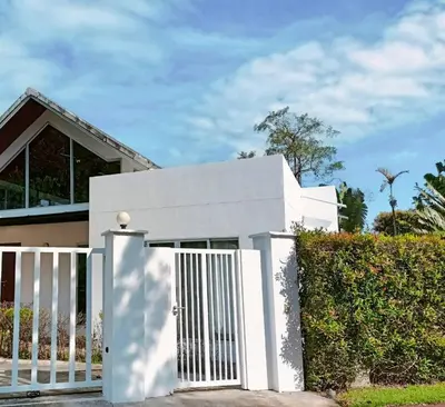 a white gate in front of a house at Villa B23 Phuket in Nai Yang Beach