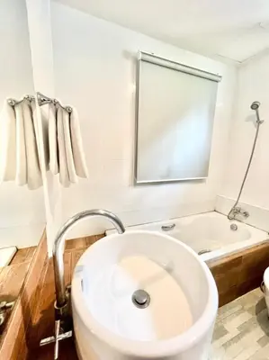 a bathroom with a white sink and a tub at Lay Back Villa C4 in Ban Nong Thale