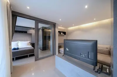 a living room with a tv and a bedroom at Tropics Kamala 2BR Apartment CTG B605-6 in Kamala Beach