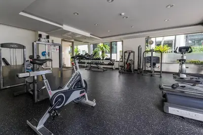 a gym with several exercise bikes and a treadmill at Kamala Regent : Beautiful Modern Apartment close to Kamala beach in Kamala Beach