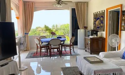 a living room with a blue table and chairs at OASIS 4 or 5 bedroom VILLA in Karon Beach