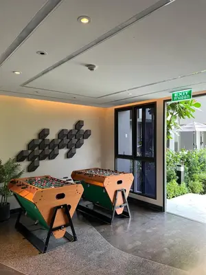 a room with two ping pong tables in front of a building at SKYPARK Building A Laguna Phuket in Bang Tao Beach