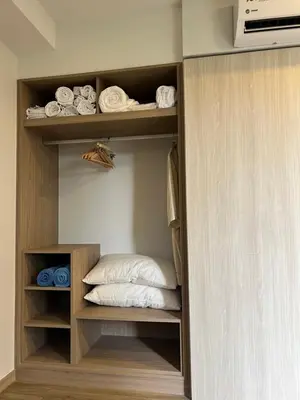 a closet with a bed and towels in it at SKYPARK Building A Laguna Phuket in Bang Tao Beach
