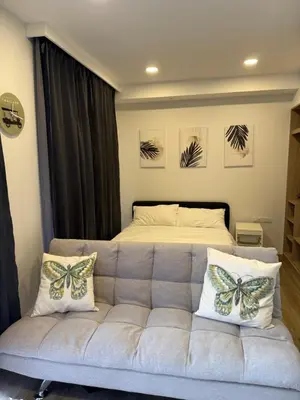 a living room with a couch and a bed at SKYPARK Building A Laguna Phuket in Bang Tao Beach