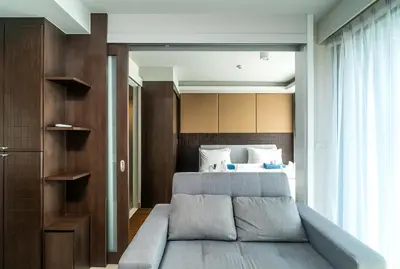 a bedroom with a bed and a large window at Private apartment at Aristo Resort by Lofty in Surin Beach