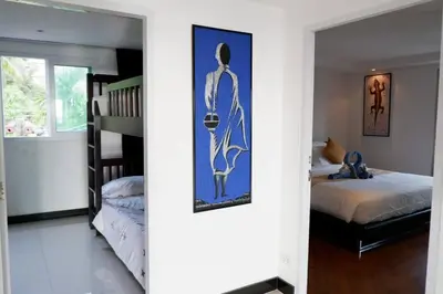 a room with a bedroom with a bed and a staircase at Kata Ocean View Luxury condo & Seaview K12 in Kata Beach