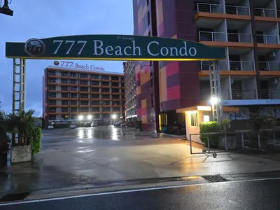 a street sign that reads beach cambodia at 777 Beach Condo Phuket in Mai Khao Beach