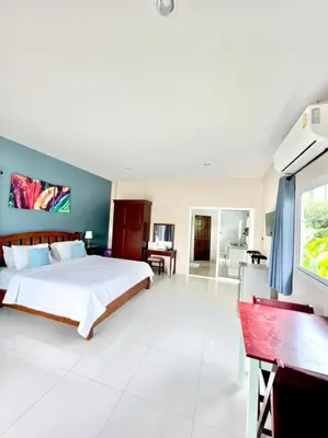 a large bedroom with a bed and a desk at Lay Back Villa C3 with Kitchen & High Speed Internet in Ban Laem Som