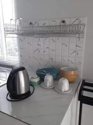 a kitchen counter with bowls and plates on it at Lay Back Villa C3 with Kitchen & High Speed Internet in Ban Laem Som