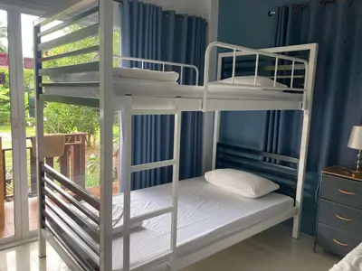 two bunk beds in a room with a window at Lay Back Villa C3 with Kitchen & High Speed Internet in Ban Laem Som