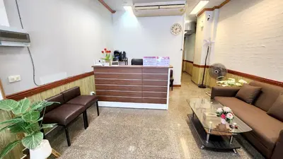 a waiting room with couches and a table in a room at Chalita House in Patong Beach