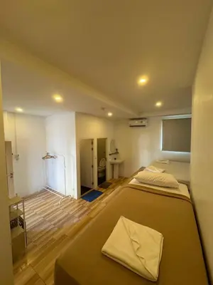 a large bedroom with two beds and a bathroom at Patong Sea U in Patong Beach