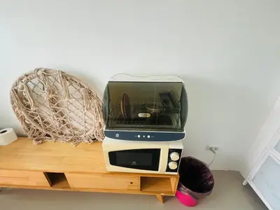 a toaster oven sitting on top of a wooden table at Phuket naka Condon-41\u65e0\u8fb9\u6cf3\u6c60\u514d\u8d39\u4e0a\u7f51\u514d\u8d39\u505c\u8f66\u4f4d in Phuket Town