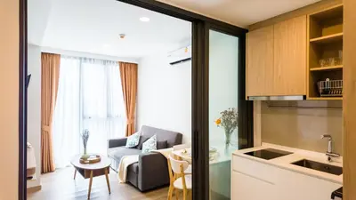 a living room with a couch and a table at Апартаменты в Лагуне SkyPark c видом на гольф поле in Bang Tao Beach