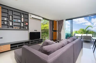 a living room with a couch and a flat screen tv at Villa Natural Touch A3 in Kamala Beach
