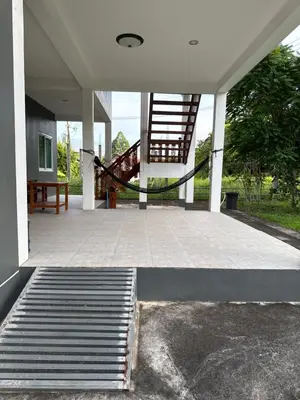 an empty patio with stairs and a stair case at Thanid House in Ban Nai Khlong