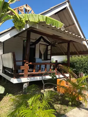 a house with a porch with a bunch of bananas on it at Pyramid Bangalow in Ban Laem Sai