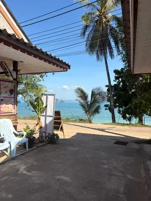a view of the ocean from the porch of a house at Pyramid Bangalow in Ban Laem Sai