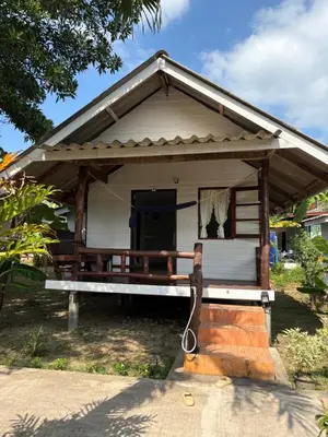 a small white house with a porch at Pyramid Bangalow in Ban Laem Sai