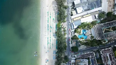 an overhead view of a beach with umbrellas at Issara Patong Beach in Patong Beach