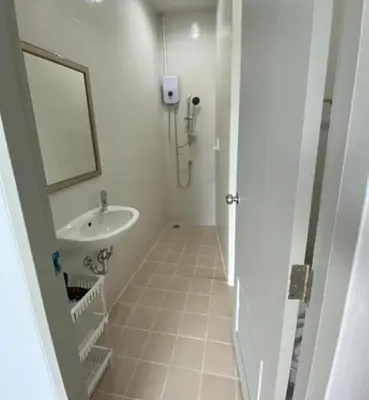 a white bathroom with a sink and a mirror at Kata Sea Blue in Kata Beach