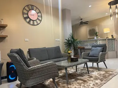a living room with a couch and chairs and a table at Kata Sea Blue in Kata Beach