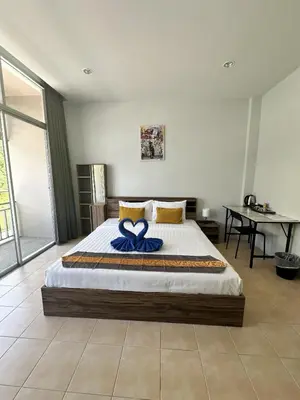 a bedroom with a bed with a blue bow on it at Kata Sea Blue in Kata Beach