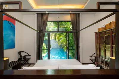 a bedroom with a bed and a view of a pool at Your Private Paradise - 2BR Tropical Pool Villa Astree in Rawai Beach