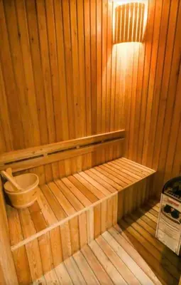 a wooden sauna with a bench in a room at Diamond Apartments Phuket Bangtao in Phuket Town