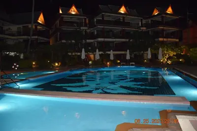 a swimming pool in front of a building at night at kalim residence 217 vue partielle mer in Patong Beach